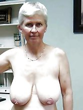 Elegant older chick playing with her tits